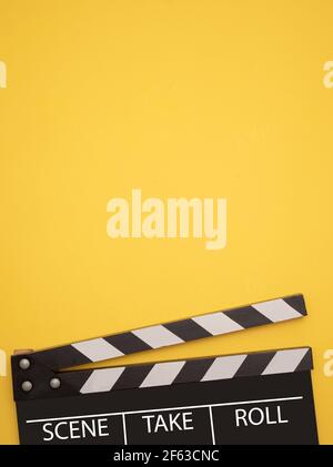 Film and film reel on yellow background Stock Photo - Alamy