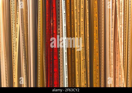Belarus, Minsk - December 19, 2019: Colored building materials and tools, plastic skirting for ceramic tiles, symbols, stencil background, plumbing ba Stock Photo