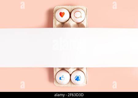 Colorful funny face made of easter eggs on pink background with copy space Stock Photo