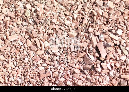 Small brown pebbles stone wall texture background Stock Photo