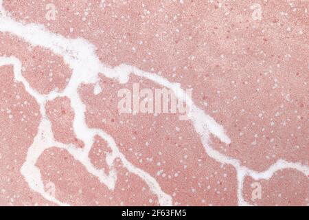 Closeup photo background of pink marble pattern with white veins. Stone texture, front view Stock Photo