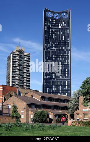 The Strata building towers over low rise housing on the Newington Estate, Elephant and Castle, London. Note wind turbines at top of tower. Stock Photo