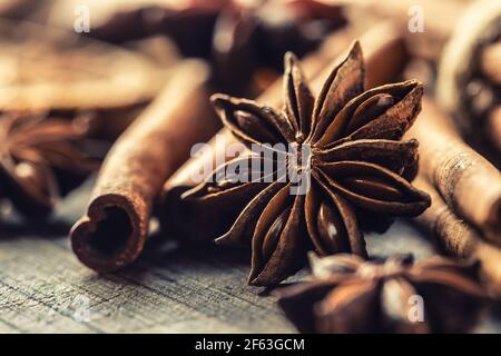 Detail of star anize and cinnamon sticks on a vintage wooden surface. Stock Photo