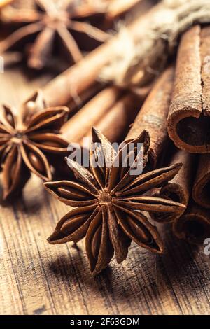 Detail of star anize and cinnamon sticks on a vintage wooden surface. Stock Photo