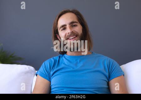 Portrait of caucasian man sitting on sofa and smiling Stock Photo