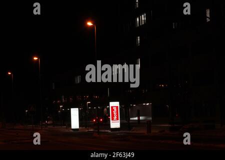 Emergency room entrance of Limmattal hospital in Schlieren, Switzerland, written in German language at night. Building of the hospital at background. Stock Photo