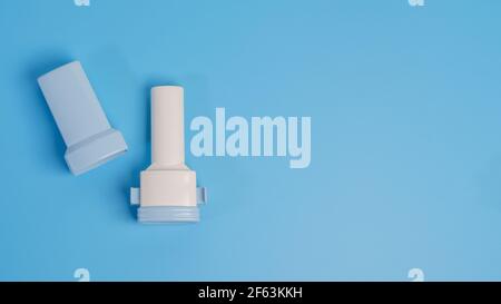 COPD or Asthma medication instruments a capsule Inhaler .On blue background. Stock Photo