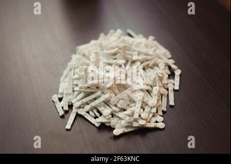 Lancets for an insulin pen on a wooden backgraund. Stock Photo