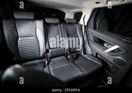 Dark luxury new car Interior. Back passenger seats in modern car. Leather backseats and seatbelts Stock Photo
