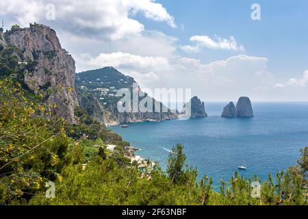 View over island of Capri with the 3 sea stacks - Stella, Faraglioni di Mezzo and Faraglione di Fuor, in the bay of Naples, Campania, Italy Stock Photo