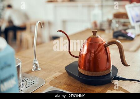 Alternative method of making coffee using a funnel filter, accessories for coffee drinks on a wooden table. Stock Photo