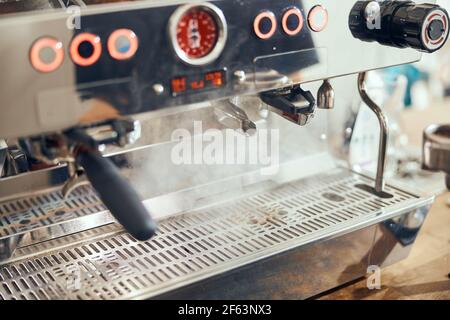 Close-up of espresso pouring from coffee machine. Professional coffee brewing Stock Photo