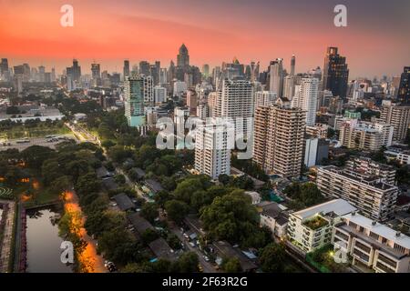 Cityscape of Bangkok, Thailand with Public Park and Skyscrapers at Sunset Stock Photo