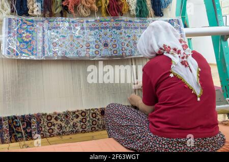 Woman weaving rug in Cappadocia, Turkey Stock Photo