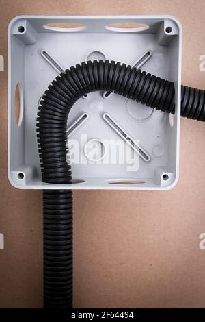 White electrical junction box with wires on beige background Stock Photo