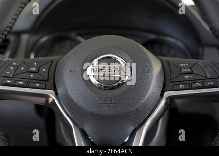 Russia, Izhevsk - February 19, 2021: Nissan showroom. Steering wheel of new Qashqai car with leather cover. Famous world brand. Stock Photo