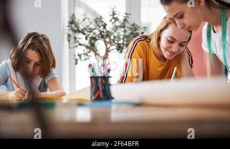 Joyful cute girls working in sewing studio Stock Photo