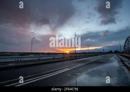 Stormy sunset over the road bridge Stock Photo