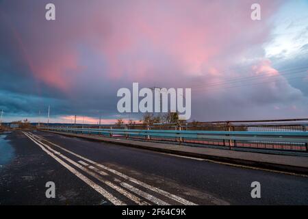 Stormy sunset over the road bridge Stock Photo
