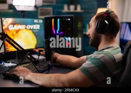 Streamer losing virtual videogames competition use professional setup with streaming chat open. Online cyber performing during gaming tournament using technology network wireless Stock Photo