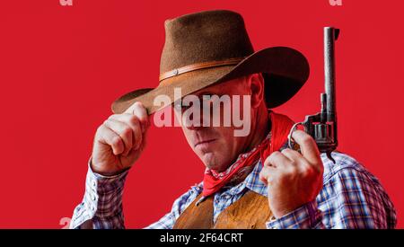 American bandit in mask, western man with hat. Man wearing cowboy hat, gun. West, guns. Portrait of a cowboy. American cowboy. Cowboy wearing hat Stock Photo