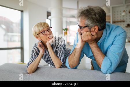 Handsome senior man and attractive old woman are having relationship problems Stock Photo