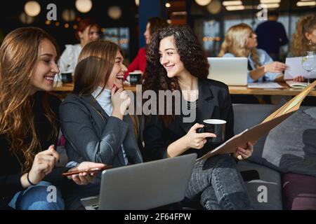 Cheerful business colleagues working together on new project Stock Photo