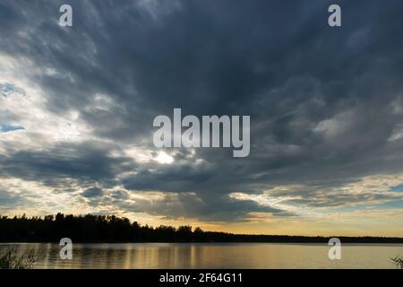 Sunset sky with rain cloud on the lake. Stock Photo