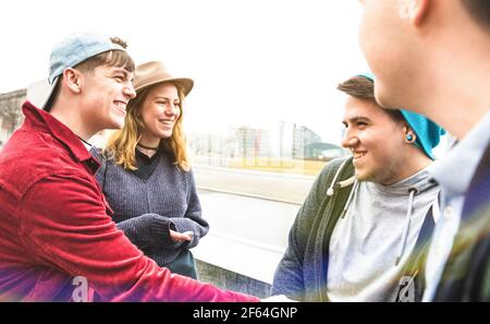Best friends millennials having genuine fun at urban area in Berlin - Friendship and youth concept with guys and girls teenagers sharing winter time Stock Photo