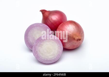 Three cloves of red onion on white background Stock Photo