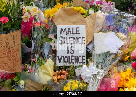 Clapham Common, London - shortly after the vigil and arrests by the poice, calmness prevails where flowers are laid in memory of Sarah Everard. Stock Photo