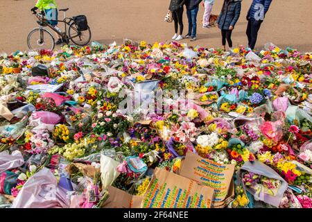 Clapham Common, London - shortly after the vigil and arrests by the poice, calmness prevails where flowers are laid in memory of Sarah Everard. Stock Photo