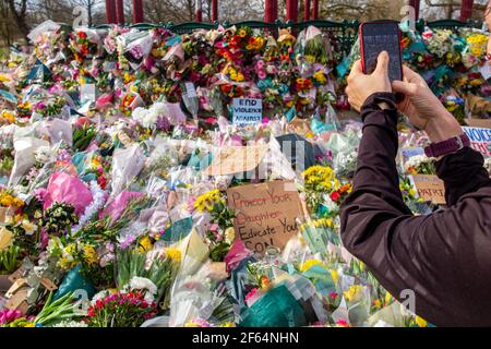 Clapham Common, London - shortly after the vigil and arrests by the poice, calmness prevails where flowers are laid in memory of Sarah Everard. Stock Photo