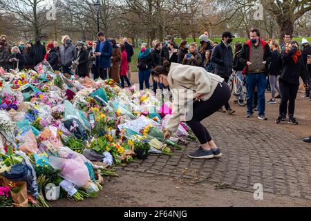 Clapham Common, London - shortly after the vigil and arrests by the poice, calmness prevails where flowers are laid in memory of Sarah Everard. Stock Photo