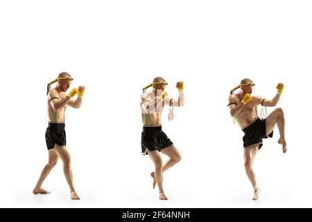 Young man thai boxer on white background in motion of step to step knee kicking. Stock Photo