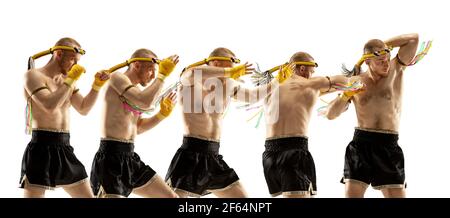 Young man professional thai boxer on white background in motion of punching. Stock Photo