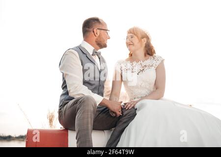 Sitting bridal couple looking at each other Stock Photo