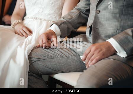 Groom and bride holding hands during wedding ceremony Stock Photo