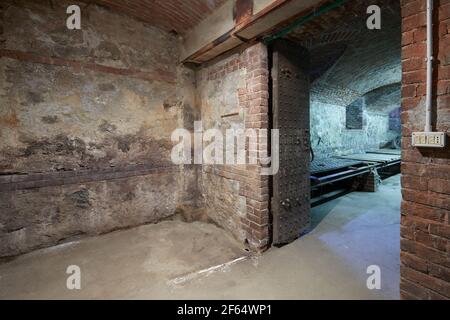 Old, empty basement with brick walls and wooden portal Stock Photo