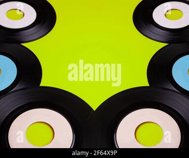 Old Vinyl 45 rpm Records on green background Stock Photo