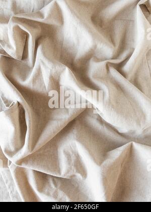 Natural textile linen with folds background. Top view Stock Photo