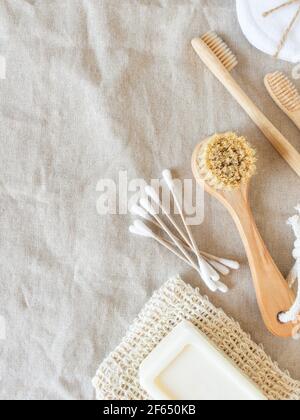 Zero waste care for women's skin. Soap, cotton buds, wood brush, toothbrushes on natural textile background. top view. Copy space Stock Photo