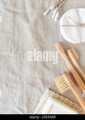 Zero waste care for women's skin. Soap, cotton buds, wood brush, toothbrushes on natural textile background. top view. Copy space Stock Photo