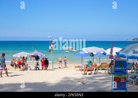 Phuket, Thailand-29.12.2018: Coast of Patong Beach on a sunny day with tourists resting. Leisure and holidays in the days before the onset of the pand Stock Photo