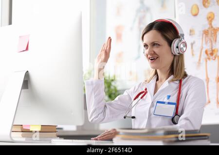 Doctor operator in call center at work desk Stock Photo