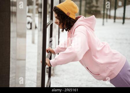 side view of african american sportswoman doing push ups on sports ground outdoors Stock Photo