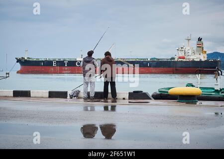 Fishermen in port of Batumi, Georgia Stock Photo