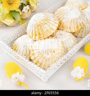 Small Easter shortbread muffins, filled with custard cream and sprinkled with powdered sugar. Stock Photo