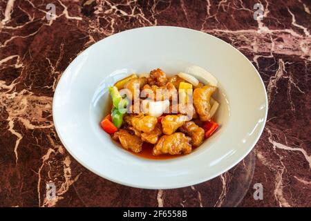 Chicken curry, tangsuyuk Japanese dish with vegetables and sauce. On a marble background, from above. Flat lay Stock Photo