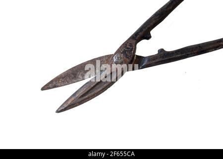 Rusty metal scissors lie on the table. Metal tools isolated on a white background Stock Photo